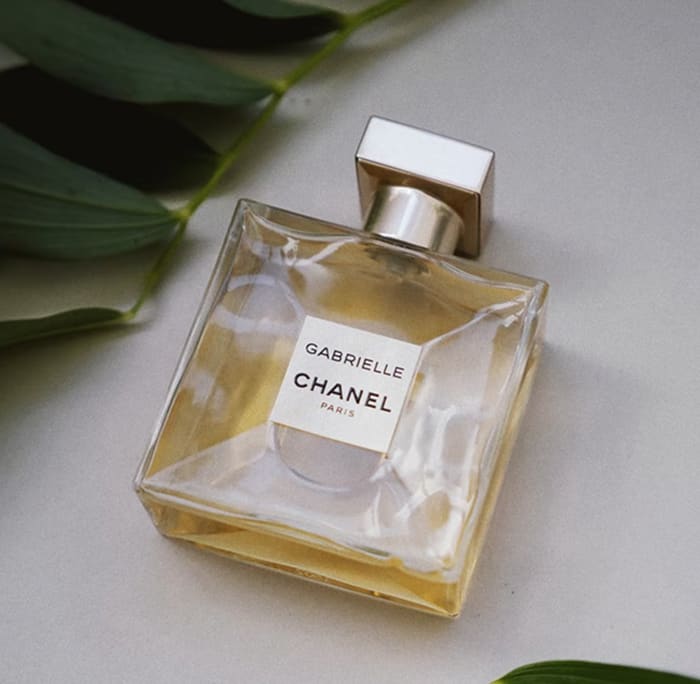 Bottle of CHANEL Perfume surrounded by leaves