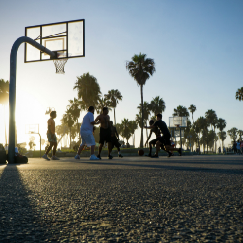 men playing 3v3 early morning casual outdoor basketball