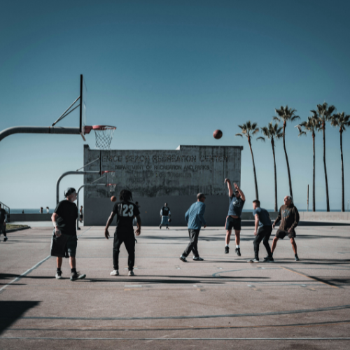 older men playing afternoon outdoor basketball